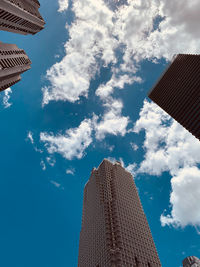 Low angle view of buildings against cloudy sky