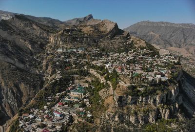 High angle view of buildings and mountains against sky