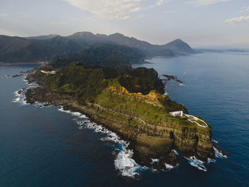 High angle view of sea and mountains against sky