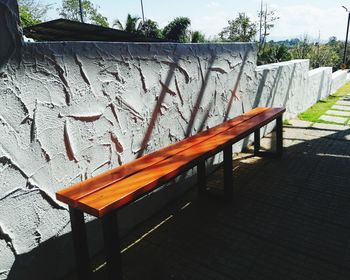 Empty chairs and table against wall