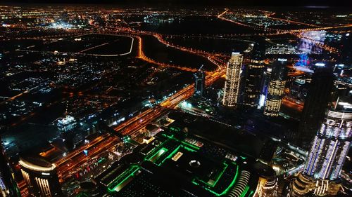 High angle view of illuminated city buildings at night