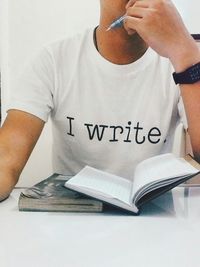 Cropped image of woman holding book