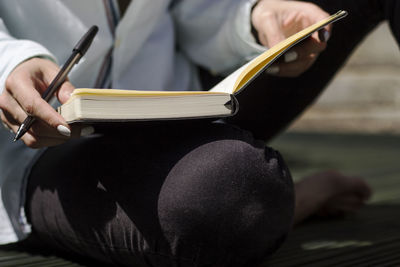 Close-up of woman reading book