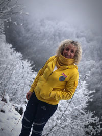 Portrait of smiling girl standing on snow