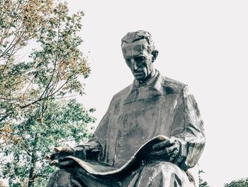 Low angle view of statue against trees