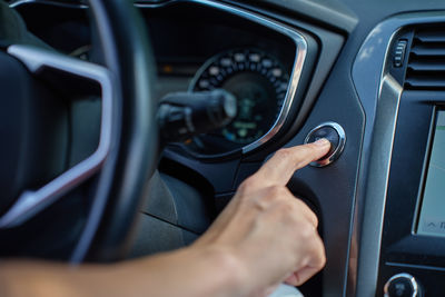 Cropped hand of man driving car