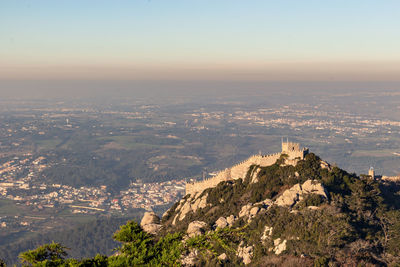 Aerial view of city and mountain against sky