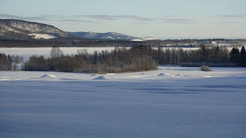 Scenic view of frozen lake against sky