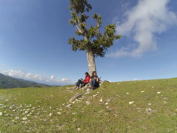 Two friends sitting under a tree. this photo was taken on 25/5/2016