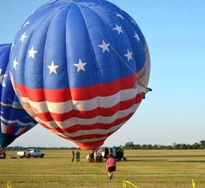 Hot air balloon on field against sky