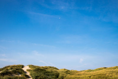 Countryside landscape against blue sky