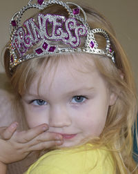 Close-up portrait of girl wearing princess crown