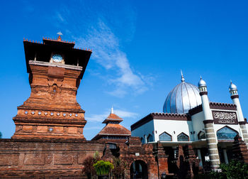 Low angle view of temple building against blue sky