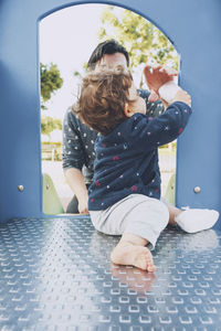 Rear view of mother and girl in traditional clothing