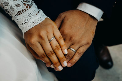 Midsection of couple holding hands