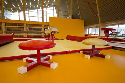 Empty chairs and tables in building