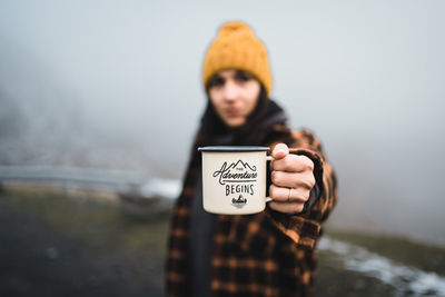 Young woman holding coffee cup