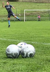 Boys playing soccer on field