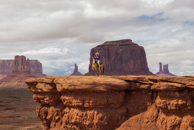 View of man riding horse against landscape