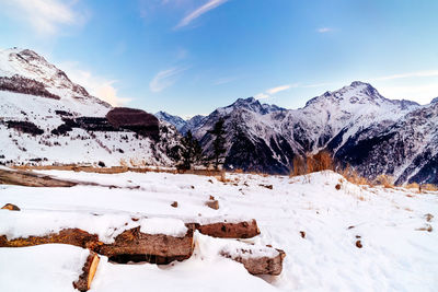 Scenic view of snow covered mountains against sky