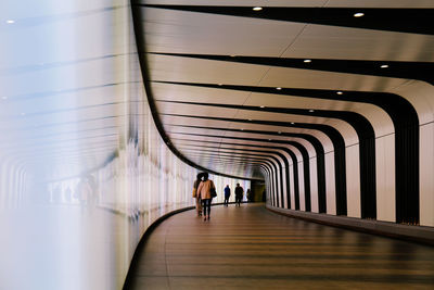 Rear view of woman walking in corridor