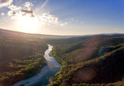 Scenic view of river against sky during sunset