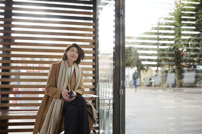 Smiling businesswoman looking away