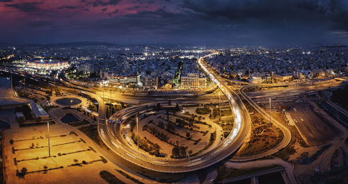 High angle view of illuminated cityscape against sky at night