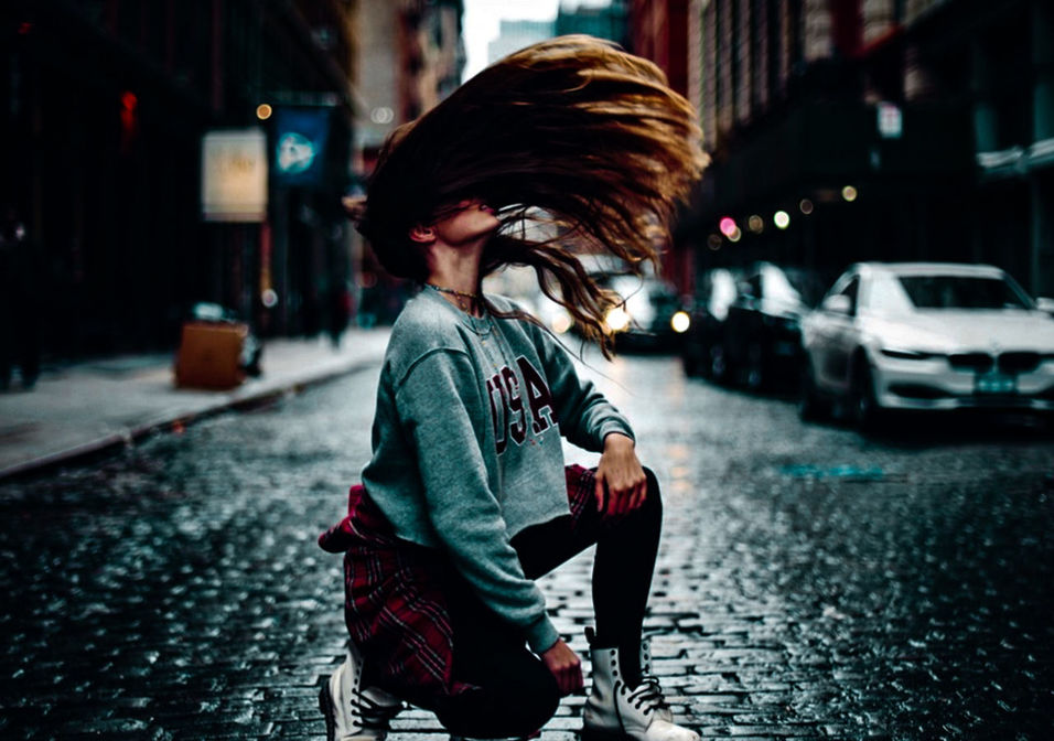 one person, city, street, real people, casual clothing, architecture, focus on foreground, transportation, lifestyles, child, childhood, side view, building exterior, road, looking away, mode of transportation, footpath, three quarter length, leisure activity, outdoors, hairstyle