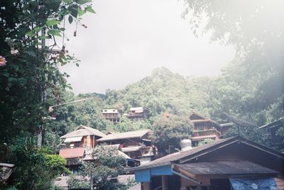 Houses in town against sky