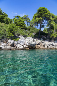 Scenic view of rocks in sea against sky