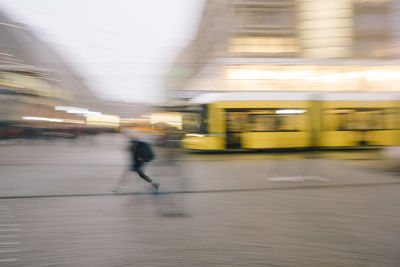 Blurred motion of person walking at subway station