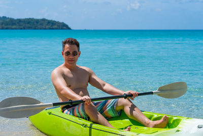 Portrait of young man swimming in sea