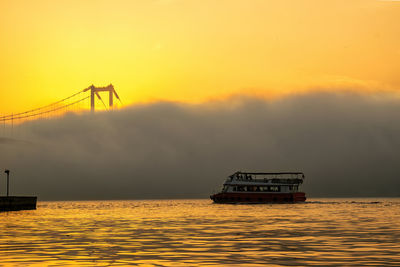 Foggy and misty scene of bosphorus bridge. bridge over the bosphorus in istanbul. a boat in the fog