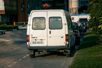 View of vehicles on road along buildings