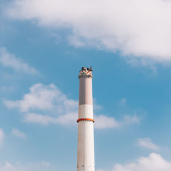 Low angle view of smoke stack against sky