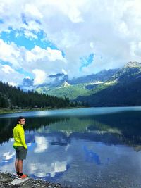 Full length of man standing on lake against sky