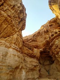 Low angle view of rock formation against sky