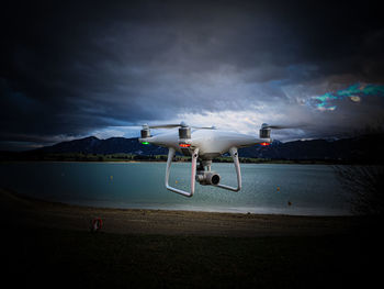 Airplane flying over sea against sky