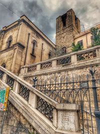 Low angle view of old building against cloudy sky