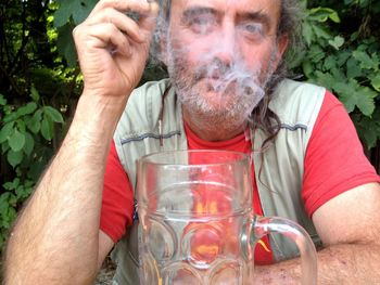 Portrait of man exhaling smoke