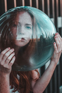 Close-up portrait of young woman wearing glass helmet in head outdoors