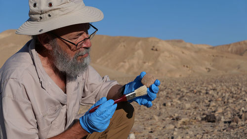 Archaeologist at work in the desert 