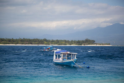 Boat sailing in sea against sky