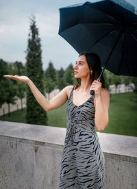 Young woman holding umbrella