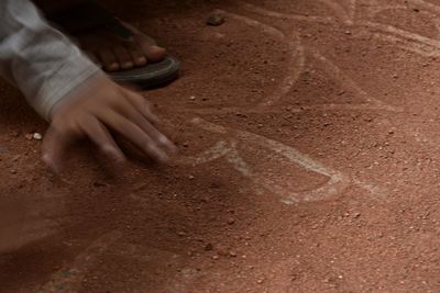 Low section of man playing sand