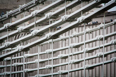 Metallic suspension bridge against building