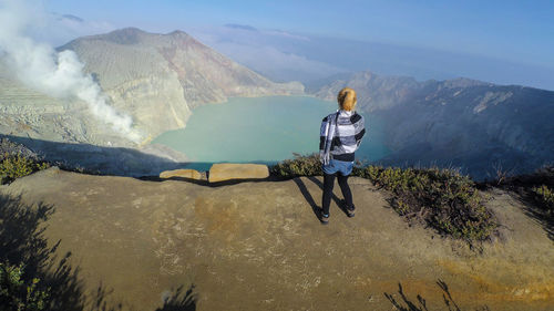 Rear view of man standing on mountain