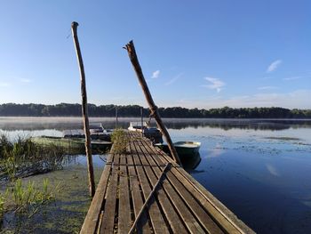 Pier over lake against sky