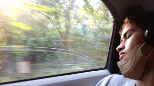 Portrait of woman seen through car window